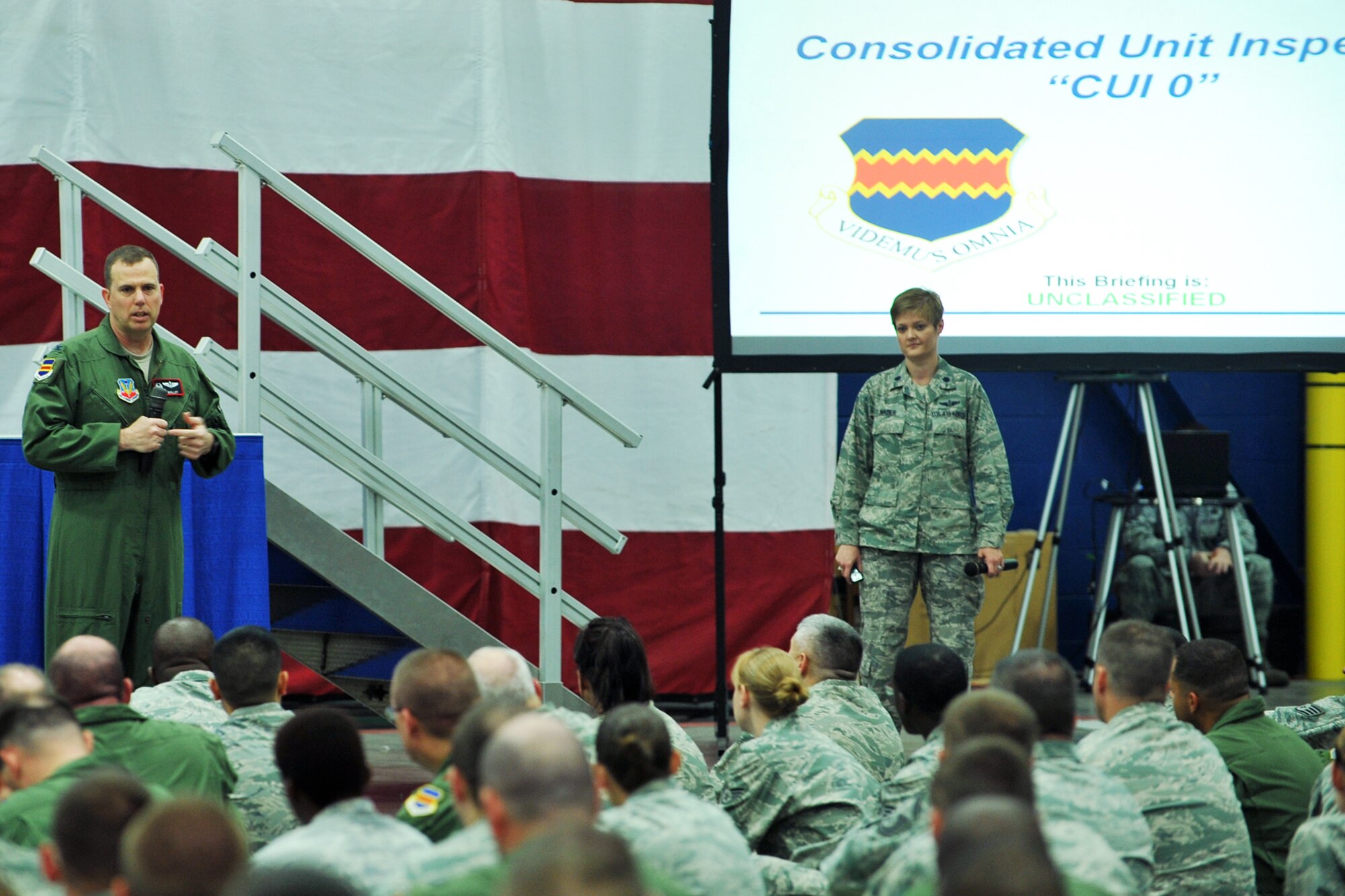 U.S. Air Force Col. Gregory Guillot, 55th Wing commander, talks to members
of the Fightin' Fifty-Fifth as U.S. Air Force Lt. Col. Nikki Nader, 55th
Wing Exercises and Inspections chief, looks on during a Consolidated Unit
Inspection briefing Aug. 9 inside the Bennie Davis Maintenance Facility at
Offutt Air Force Base, Neb. The commander used the briefing to make sure the
wing understood where they were in regards to preparation and the way ahead
as they will participate in 10 inspections throughout September, nine
simultaneously, including the CUI. (Photo by Charles Haymond/Released)
