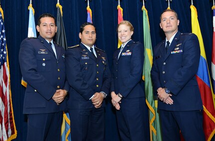 Colombia air force Capt.Carlos Monroy (left) and Dominican Republic air force Capt. Daniel Yapor stand with their new friends and fellow graduates, U.S. Air Force Capts. Lacey Thompson and Dayvid Prahl. The four offi cers built their friendships through the Inter-American Air Forces Academy International Squadron Offi cers School Professional Military Education class at Joint Base San Antonio-Lackland.