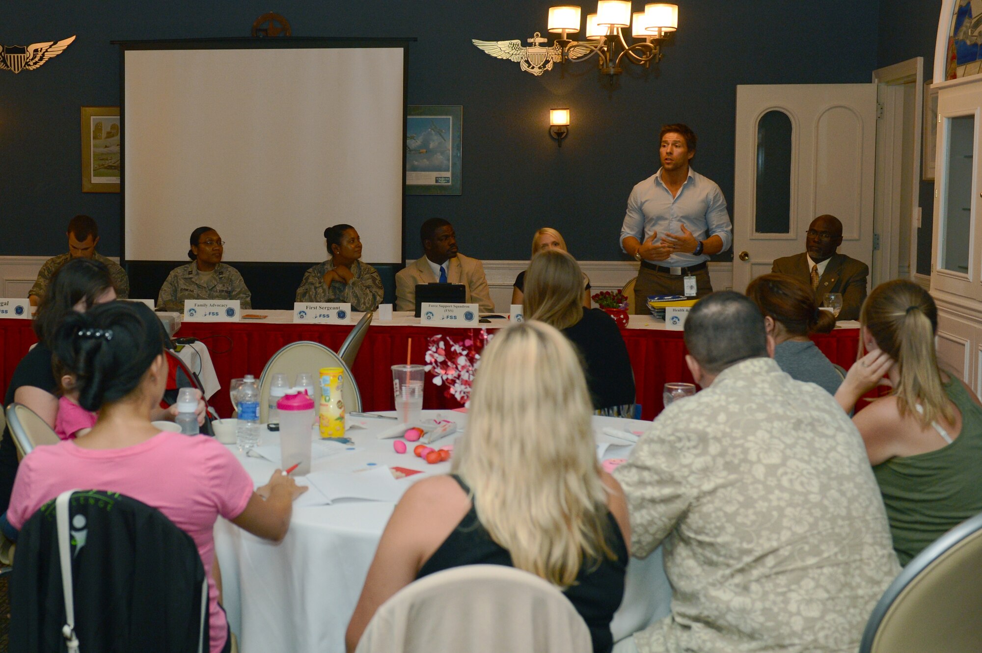 Erik Edwards, 20th Aerospace Medicine Squadron health fitness specialist, speaks to spouses about the services available to them at the Health and Wellness Center during an event called Heart Link at the Carolina Skies Club and Conference Center at Shaw Air Force Base, S.C., Aug. 13, 2013. Heart Link is a quarterly orientation for spouses where they are introduced to representatives from different units that have services for spouses. (U.S. Air Force photo by Airman 1st Class Krystal M. Jeffers/Released)