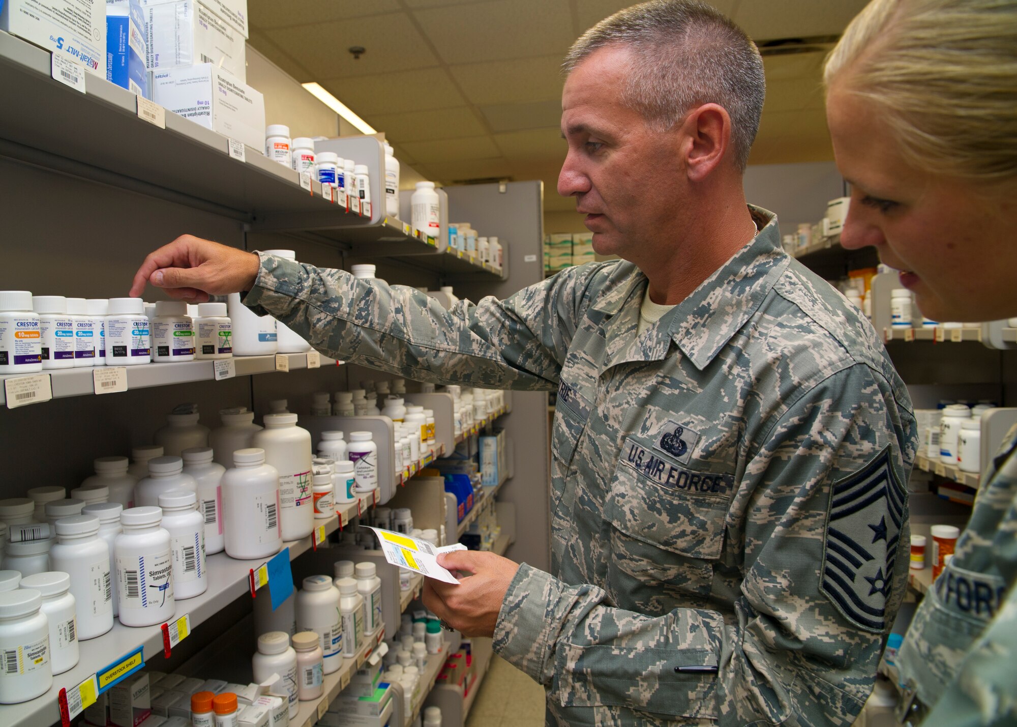49th Wing Command Chief Master Sgt. James Patrie, searches for prescriptions as he shadows a pharmacist at Holloman Air Force Base, N.M., Aug. 14. Patrie learned how the pharmacy worked by filling prescriptions, logging information and distributing medications to patients. (U.S. Air Force photo by Airman 1st Class Leah Murray/Released)
