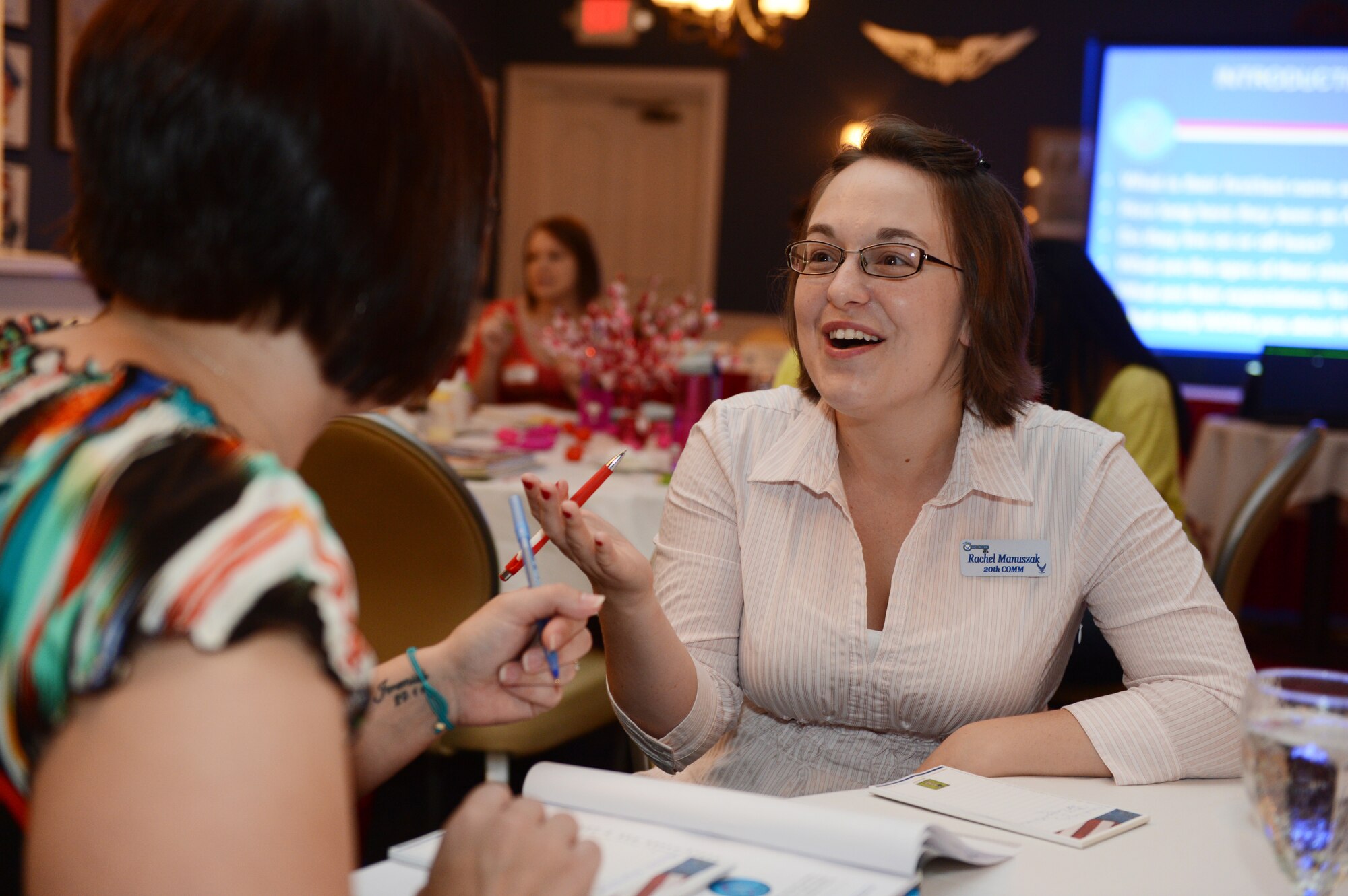 Rachel Manuszak (right), 20th Fighter Wing key spouse, and Amanda Langley, a military spouse, introduce themselves during Heart Link at the Carolina Skies Club and Conference Center at Shaw Air Force Base, S.C., Aug. 13, 2013. Heart Link is a quarterly orientation for spouses to introduce them to military life. (U.S. Air Force photo by Airman 1st Class Krystal M. Jeffers/Released)