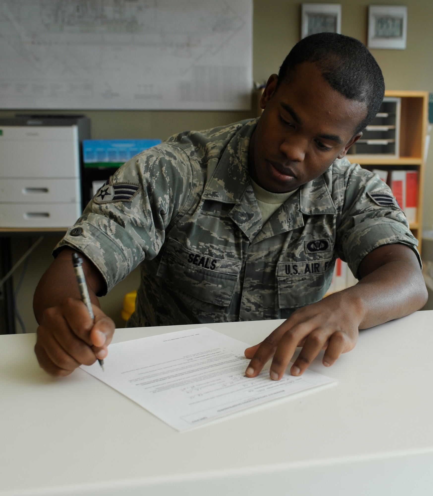 U.S. Air Force Senior Airman James Seals, 366th Operations Support Squadron airfield management shift lead, fills out paperwork, Aug. 13, 2013, at Mountain Home Air Force Base, Idaho. Airfield management personnel are determined to always stay productive despite fluctuating operation tempos. (U.S. Air Force photo by Airman 1st Class Shane M. Phipps/Released)
