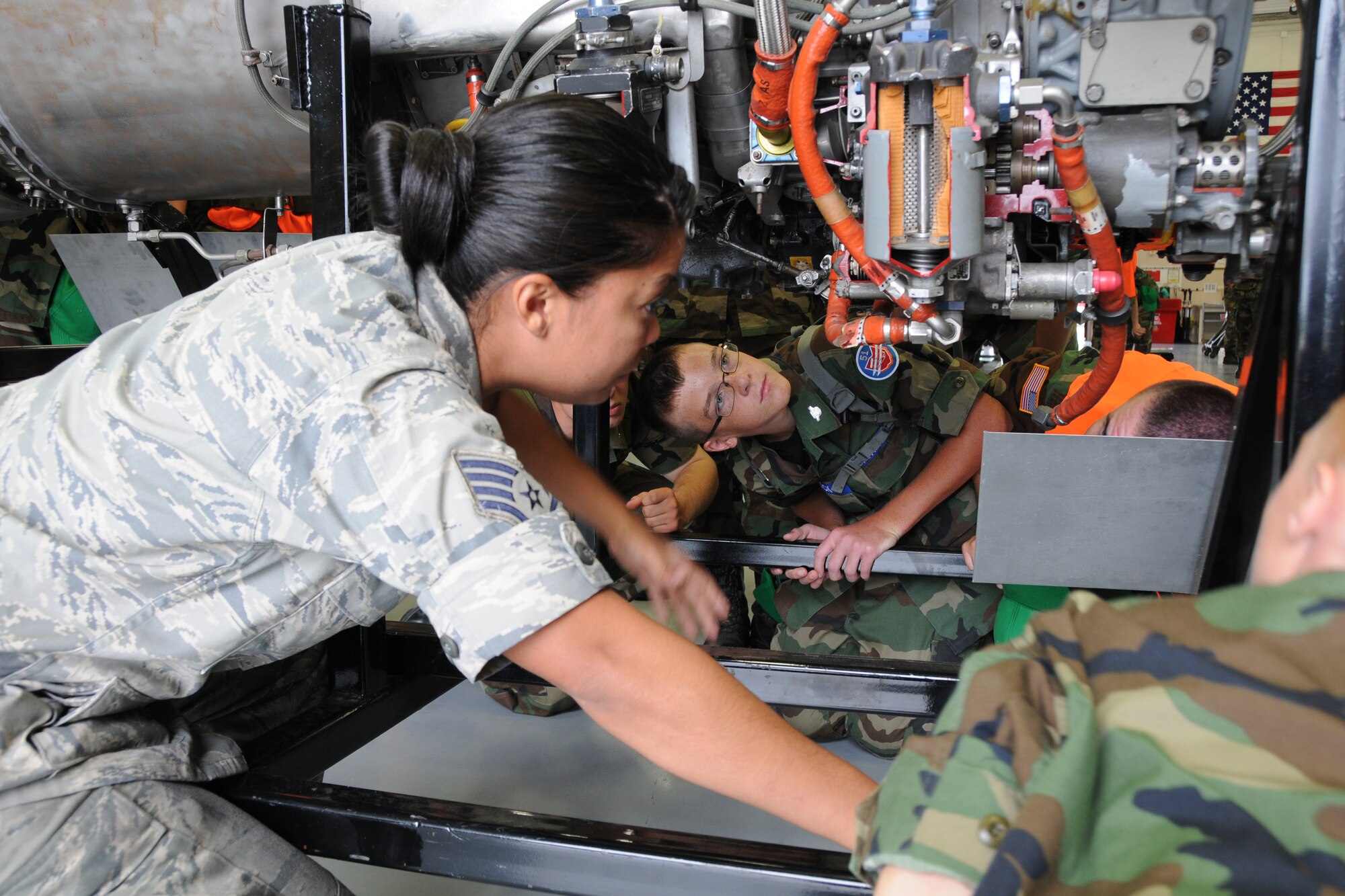 YOUNGSTOWN AIR RESERVE STATION, Ohio--Staff Sgt. Jenelle Rodriguez, an aerospace propulsion journeyman with the 910th Maintenance Squadron, explains the components of a C-130H Hercules aircraft cut away engine to Civil Air Patrol cadets here, July 31. The Civil Air Patrol toured facilities including the propulsion shop, Navy and Marine Corps Reserve Center and the 910th aerial Spray shop. U.S. Air Force photo by SrA Rachel Kocin.