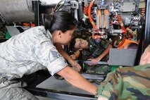 YOUNGSTOWN AIR RESERVE STATION, Ohio--Staff Sgt. Jenelle Rodriguez, an aerospace propulsion journeyman with the 910th Maintenance Squadron, explains the components of a C-130H Hercules aircraft cut away engine to Civil Air Patrol cadets here, July 31. The Civil Air Patrol toured facilities including the propulsion shop, Navy and Marine Corps Reserve Center and the 910th aerial Spray shop. U.S. Air Force photo by SrA Rachel Kocin.