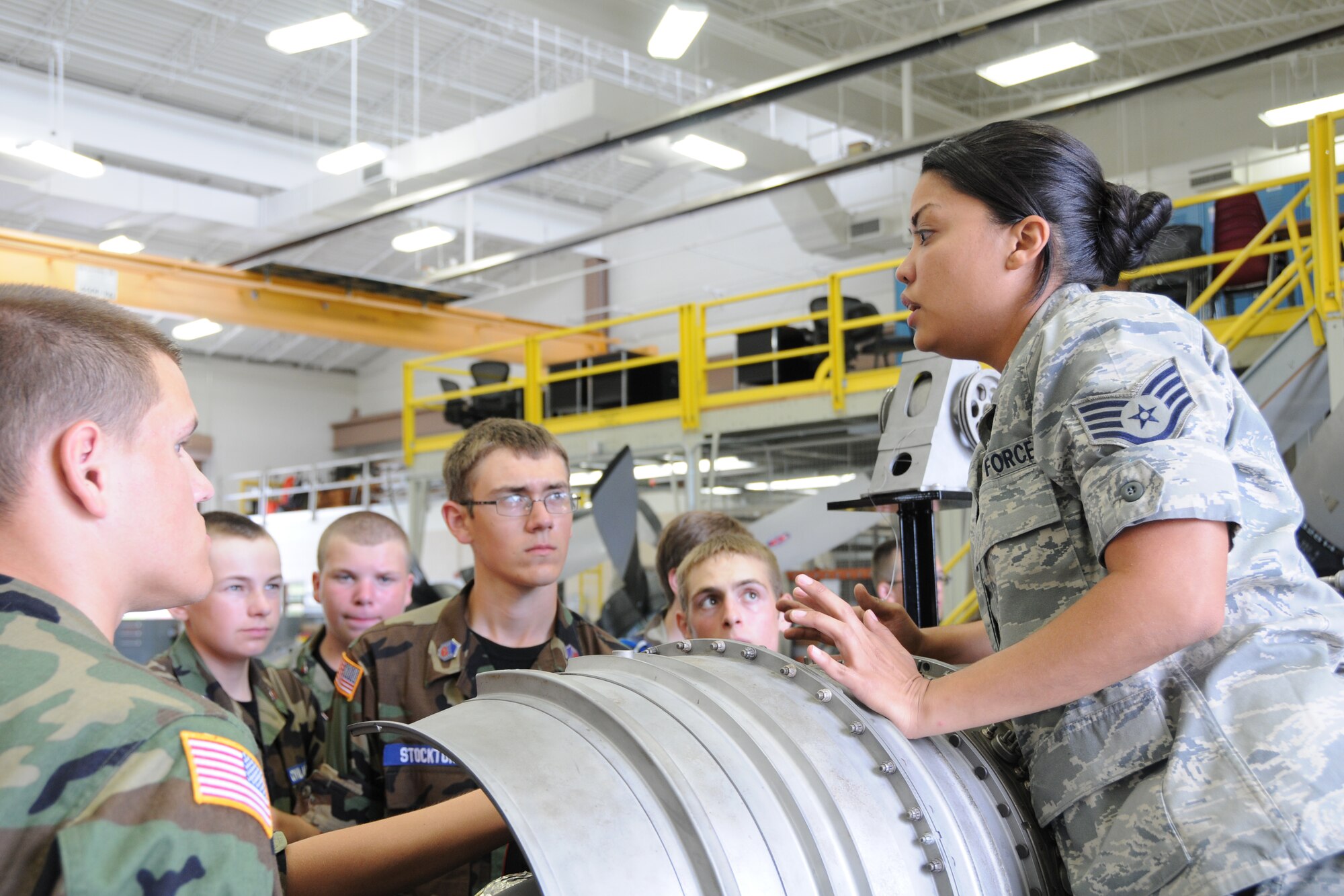 YOUNGSTOWN AIR RESERVE STATION, Ohio—Air Force Reserve Staff Sgt. Jenelle Rodriguez, an aerospace propulsion journeyman with the 910th Maintenance Squadron, explains the components of a C-130H Hercules aircraft cut away engine to Civil Air Patrol cadets here, July 31. The Civil Air Patrol toured facilities including the propulsion shop, Navy and Marine Corps Reserve Center and the 910th aerial Spray shop. U.S. Air Force photo by SrA Rachel Kocin.