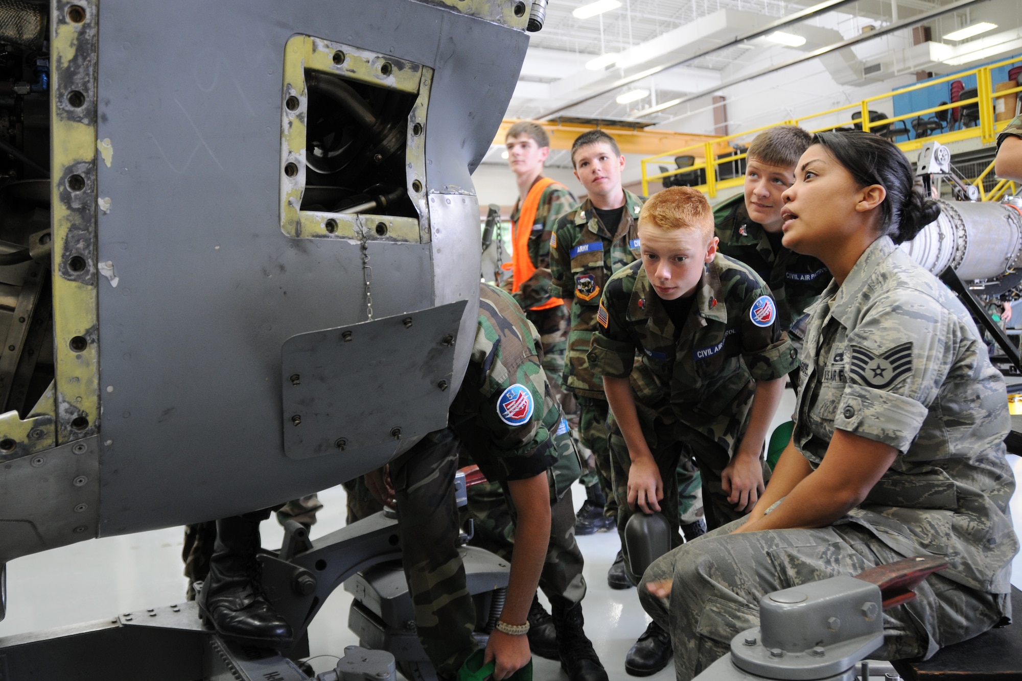YOUNGSTOWN AIR RESERVE STATION, Ohio—Air Force Reserve Staff Sgt. Jenelle Rodriguez, an aerospace propulsion journeyman with the 910th Maintenance Squadron, explains the intake of the C-130 T56 Alison engine to Civil Air Patrol cadets here, July 31. The Civil Air Patrol toured facilities including the propulsion shop, Navy and Marine Corps Reserve Center and the 910th aerial spray facilities. U.S. Air Force photo by SrA Rachel Kocin.