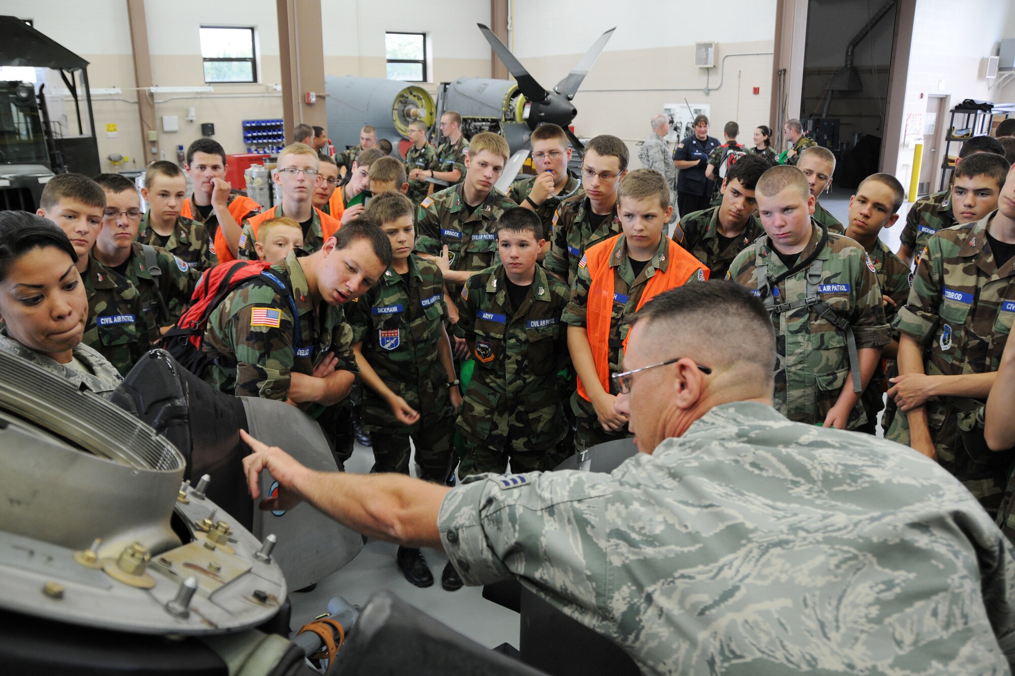 YOUNGSTOWN AIR RESERVE STATION, Ohio—Air Force Reserve SrA Jerry Winkler, an aerospace proplusion helper, and Staff Sgt. Jenelle Rodriguez, an aerospace propulsion journeyman, both with the  910th Maintenance Squadron, explain the functioning of a C-130H Hercules propeller to Civil Air Patrol cadets here, July 31.  The Civil Air Patrol toured facilities including the propulsion shop, Navy and Marine Corps Reserve Center and the 910th aerial spray facilities. U.S. Air Force photo by SrA Rachel Kocin.