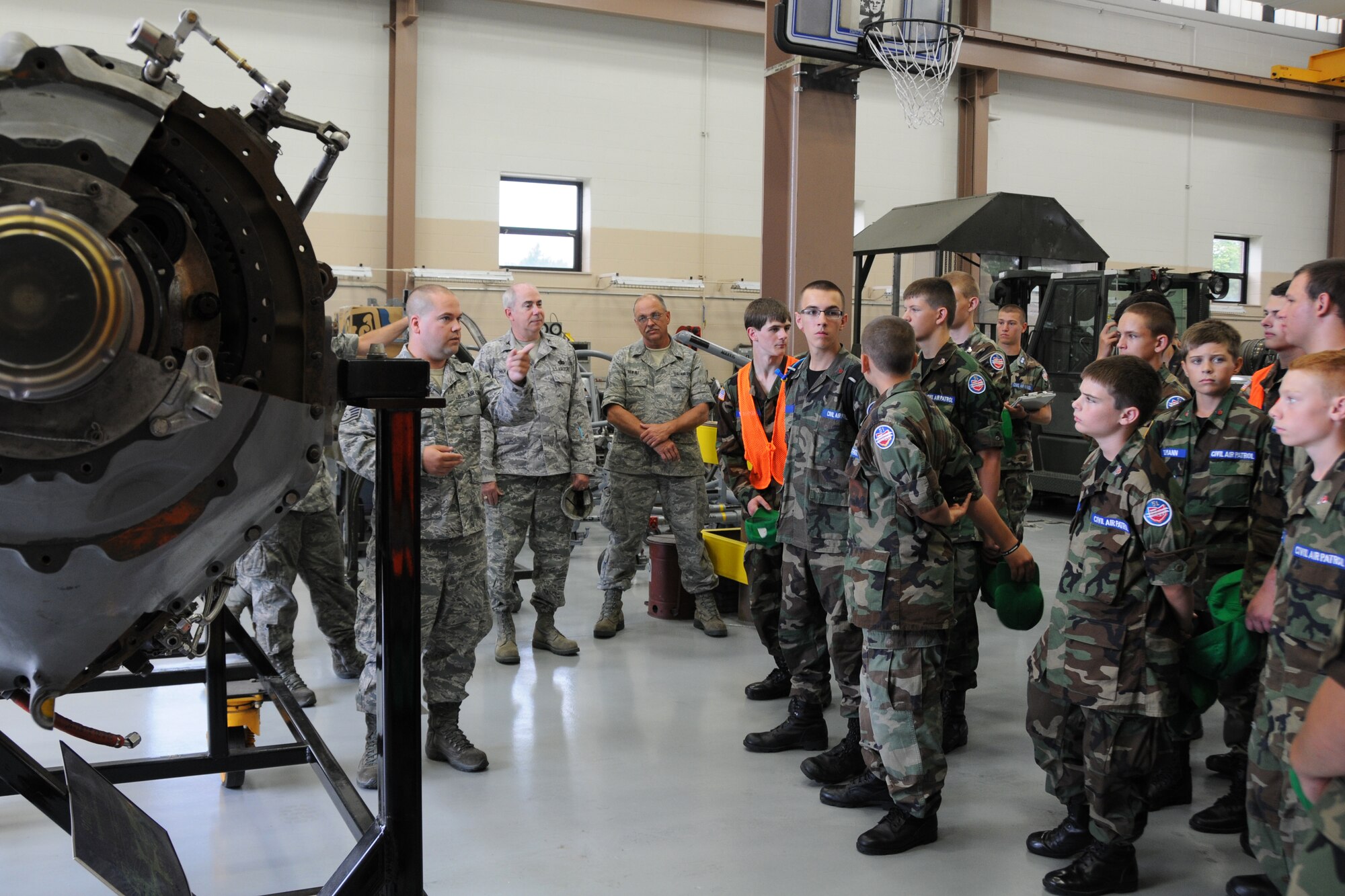YOUNGSTOWN AIR RESERVE STATION, Ohio—Air Force Reserve Staff Sgt. Derek Pressell, an aerospace proplusion technician, with the  910th Maintenance Squadron explains the components of a C-130H Hercules aircraft cut away engine to Civil Air Patrol cadets. The Civil Air Patrol toured facilities including Propulsion shop, Navy and Marine Corps Reserve center and the 910th aerial spray facilities. U.S. Air Force photo by SrA Rachel Kocin.