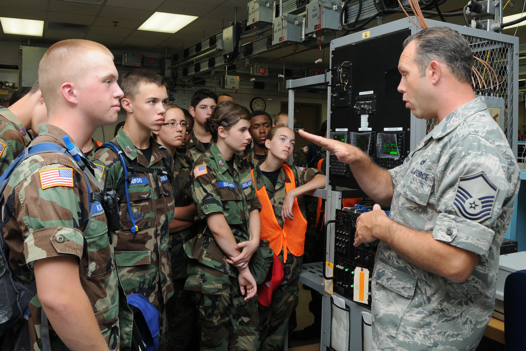 YOUNGSTOWN AIR RESERVE STATION, Ohio—Air Force Reserve Master Sgt. Dan Bryant, a communication and navigation systems craftsman with the 910th Maintenance Squadron, explains the components of avionics equipment to Civil Air Patrol cadets, July 31, here. The Civil Air Patrol toured base facilities including Propulsion, the Navy and Marine Corps Reserve center and the 910th aerial spray facilities. U.S. Air Force photo by SrA Rachel Kocin.