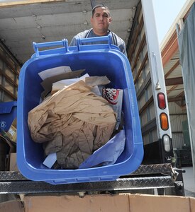 Gerardo Gutierrez, JBSA-Randolph Recycle Center technician, transfers paper prior to recycling Aug. 8. (U.S. Air Force photo by Don Lindsey/ Released)
