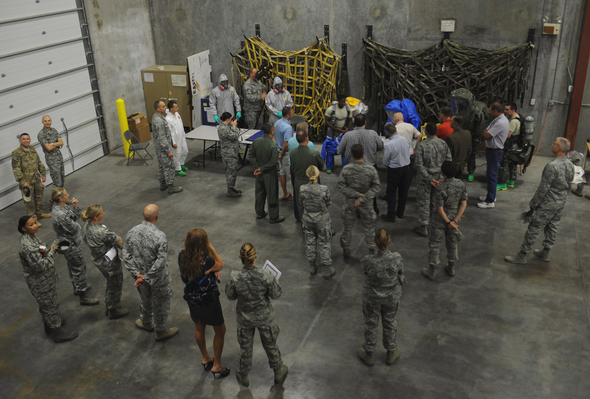 Members of the 366th Fighter Wing and honorary commanders watch a biomedical equipment demonstration Aug. 14, 2013, at Mountain Home Air Force Base, Idaho. Local civic leaders participated in a mock-deployment in order to witness how Gunfighter medics support the mission. (U.S. Air Force photo by Senior Airman Benjamin Sutton/Released)