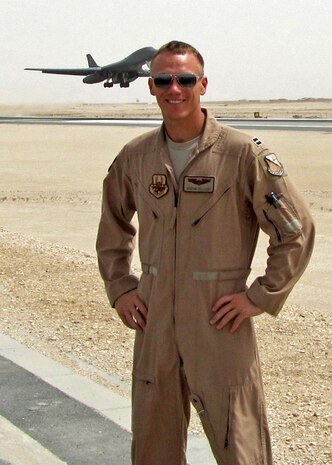 Capt. Dustin poses for a photo during his deployment to Afghanistan in 2012 where he served as an aircraft commander for a B-1B Lancer. In the background a Lancer takes flight. Dustin and his aircrew have been named the Air Force’s 2012 bomber crew of the year and were awarded the Air Force Association’s Gen. Curtis E. Lemay Award. (Courtesy photo)