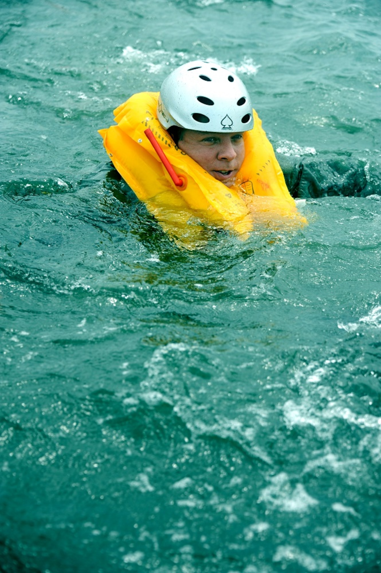 An aircrew member swims to shore from his KC-10 Extender raft during a Survival, Evasion, Resistance and Escape water survival class Aug. 8, 2013, at Long Beach Island, N.J. The students had to swim from the raft to shore because the tide will not push the raft completely to shore. (U.S. Air Force photo by Airman 1st Class Sean M. Crowe/Released)
