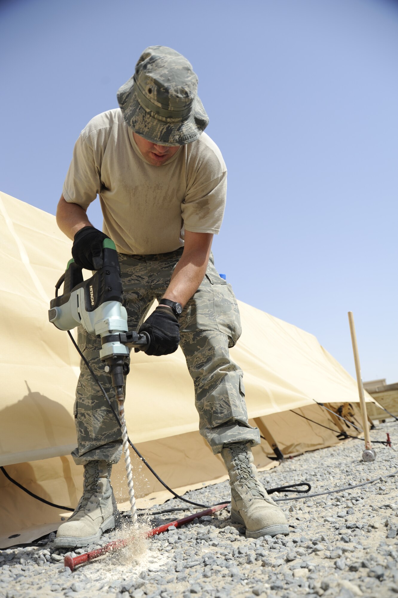 SOUTHWEST ASIA -- An Airman at a base here works to install tents equipped with new energy-saving technology. The tents are part of a joint research project between the Air Force and the Army and will be monitored to see how they perform in the soaring temperatures and desert winds of the AOR. (U.S. Air Force photo/Master Sgt. Christopher Campbell)