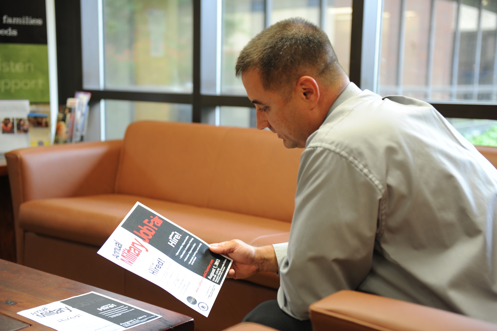 U.S. Air Force Senior Master Sgt. Martin Zeigler, Combat Air Forces munitions policy manager at Headquarters Air Combat Command, looks at a flyer advertising a job fair through the Transition GPS (Goals, Plans and Success) program at Langley Air Force Base, Va., Aug. 1, 2013. Transition GPS places greater emphasis on a smooth transition into the civilian world, cutting down on joblessness in post-9/11 veterans. (U.S. Air Force photo by 2nd Lt. Brooke Betit/Released)