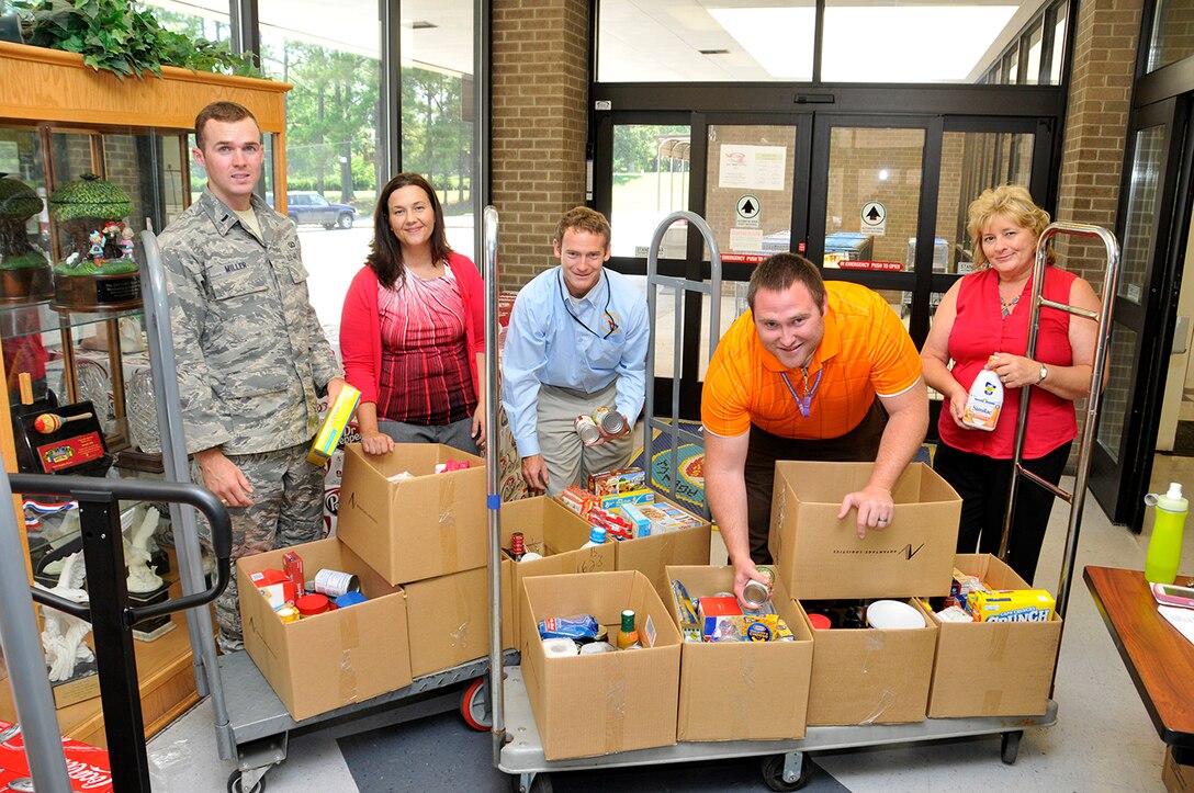 From left, AEDC personnel 1st Lt. Drew Miller, Melissa Tate, Will Mallory, Marcus Conner and Peggy Proffitt prepare AEDC donated food for the Feds Feed Families food drive at the Arnold AFB Commissary. The collected food will be distributed to local food banks for needy families. The food drive will continue through Aug. 31 at AEDC.
