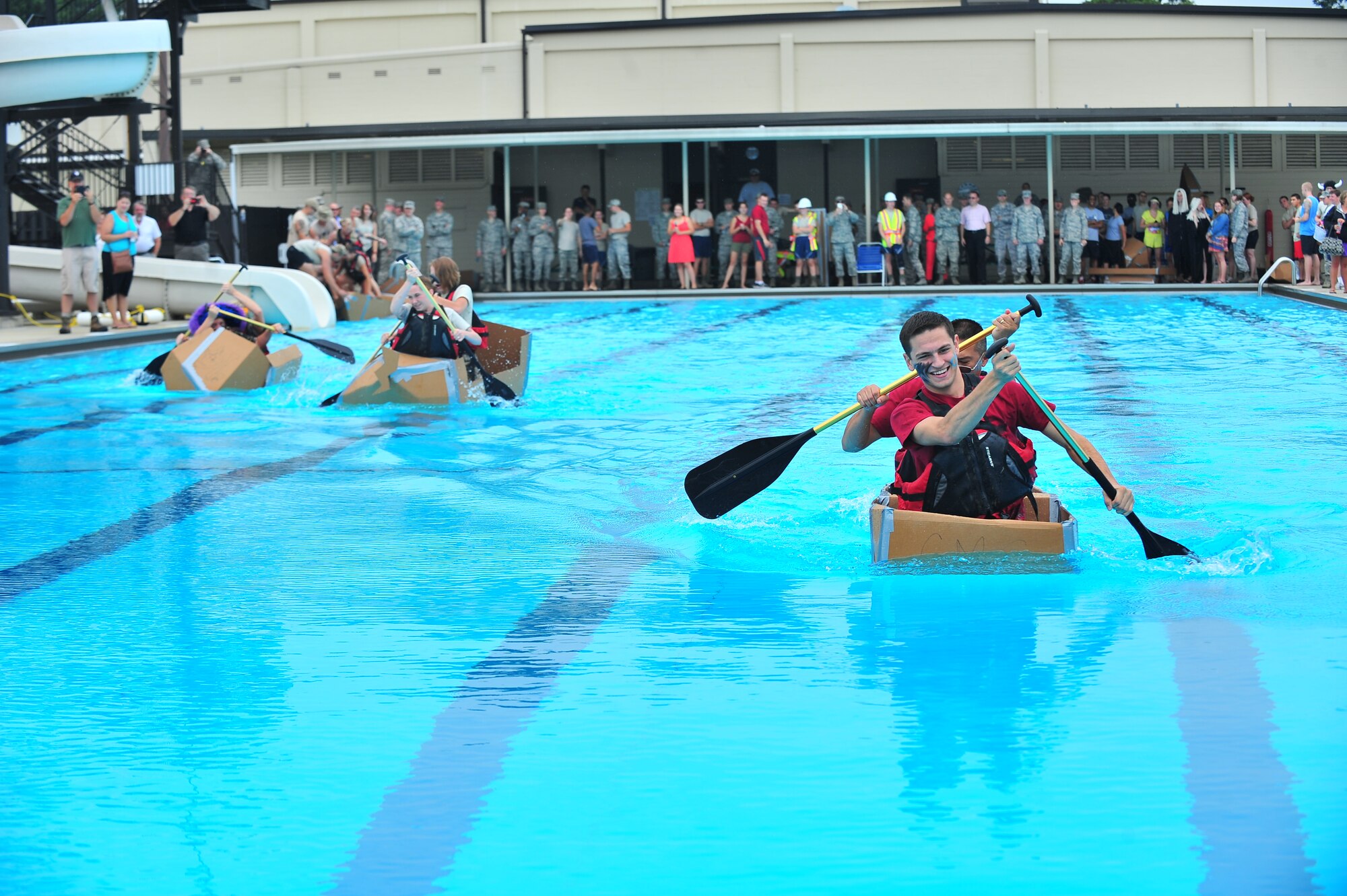 The 4th Component Maintenance Squadron team leads a race during the Build-a-Boat competition at Seymour Johnson Air Force Base, N.C., Aug. 14, 2013. More than 10 teams representing several squadrons and private organizations that built boats made of cardboard and duct tape, then raced against one another for the fastest time. (U.S. Air Force photo by Senior Airman Aubrey White/Released)