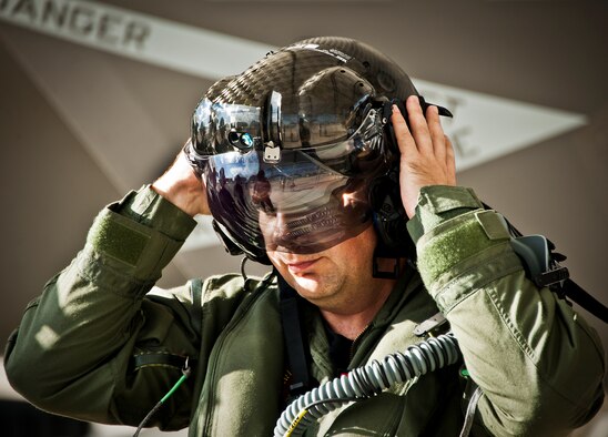 Lt. Cdr. Chris Tabert puts on the specialized helmet before piloting the first F-35C Lightning II flight at Eglin Air Force Base Aug. 14. Before arriving to U.S. Navy F-35 Strike Fighter Squadron VFA 101 in February, he served as a test pilot for the joint strike fighter program at Naval Air Station Patuxent River. He will become the squadron's first instructor pilot and join a collocated team of Marine, Navy, Air Force and international partners training here.  (U.S. Air Force photo/Samuel King Jr.) 
