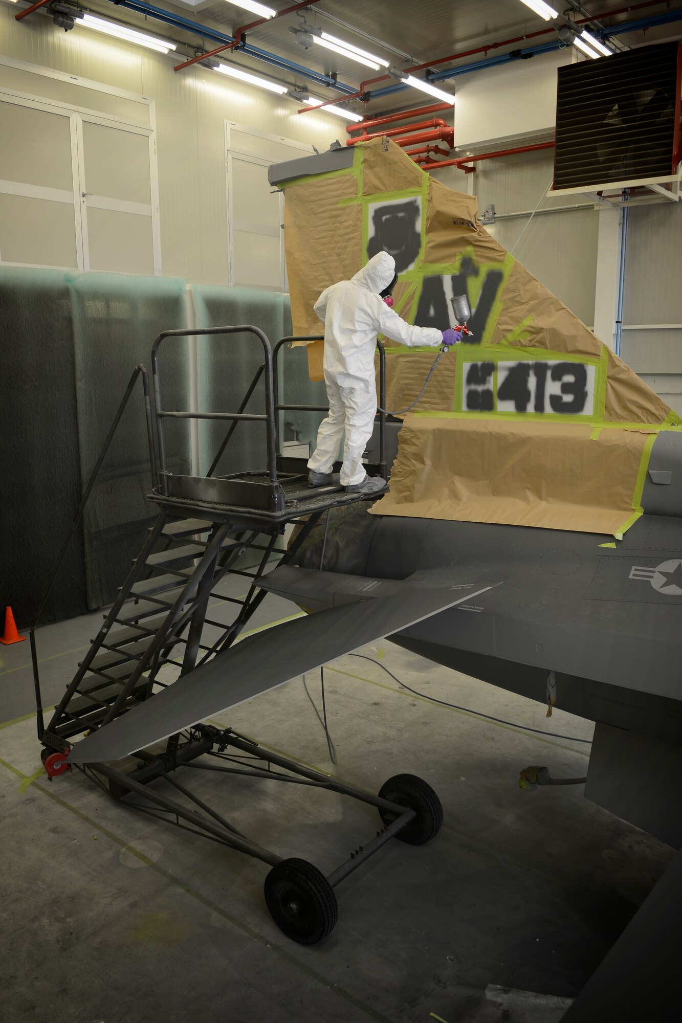 Francesco Di Carlo, 31st Maintenance Squadron corrosion technician, paints the tail end of an F-16 Fighting Falcon Aug. 13, 2013 at Aviano Air Base, Italy. Corrosion control focuses on preventative maintenance by sanding down and repainting aircraft through the use of special polyurethane paint, which helps protect the metal from environmental stressors. (U.S. Air Force photo/Senior Airman Jessica Hines) 
