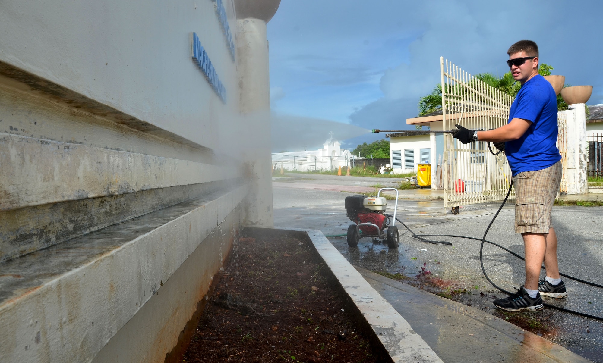 YIGO, Guam—Airman 1st Class Eli Nunez, 36th Logistic Readiness Squadron fuel prevention maintenance technician, pressure-washes an entrance sign during a school beautification project at the Machananao Elementary School in Yigo, Guam, Aug. 14, 2013. The week-long combined efforts of Andersen Air Force Base volunteers and U.S. Army units were to prepare Machananao Elementary School for the upcoming school year.  (U.S. Air Force photo by Staff Sgt. Benjamin Wiseman/Released)