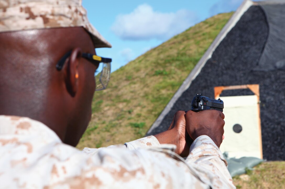 Master Sgt. Bill J. Shaw Jr. aims at his target using the new three-dot sight of his M9A1 July 26 at a pistol range at Camp Hansen for qualification. Marine Corps Administrative Message 124/12 permits the M9A1 9 mm pistol to be used during annual pistol training. Shaw is a supply administration and operations specialist with Headquarters and Service Battalion, Marine Corps Base Camp Smedley D. Butler, Marine Corps Installations Pacific. Photo by Sgt. Anthony Kirby