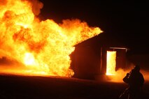 ARF Marines from Marine Wing Support Squadron 272 burn down a Southwest Asian style hut in a controled environment to get a visual representation of how long it would take to burn down at Camp Wilson aboard Marine Corps Air-Ground Combat Center Twentynine Palms, Calif., August 4. 