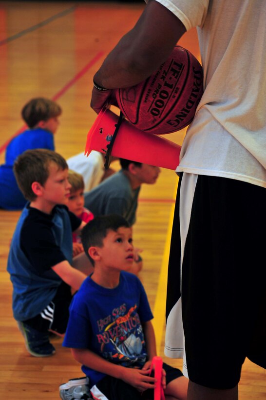 Jernavis Draughn, chief executive officer of Athletes Global, teaches a drill during a basketball camp at the Barber Physical Activities Center on Aug. 13, 2013. The week-long camp was hosted for children ages 5-14.