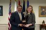 Angela Wilson, the Defense Department Education Activity's Teacher of the Year, accepts an award from Defense Secretary Leon E. Panetta in the Pentagon, Oct. 2, 2012.