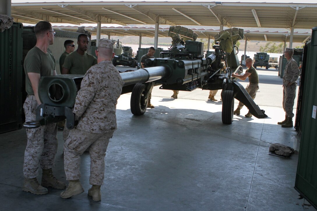 Field artillery Marines serving with Charlie Battery, 1st Battalion, 11th Marine Regiment, move an M777 Lightweight Howitzer after providing preventative maintenance at the 11th Marines gun park here, Aug. 14, 2013. The Marines prepped the howitzer for the upcoming regimental fire exercise Aug. 19 through 28.