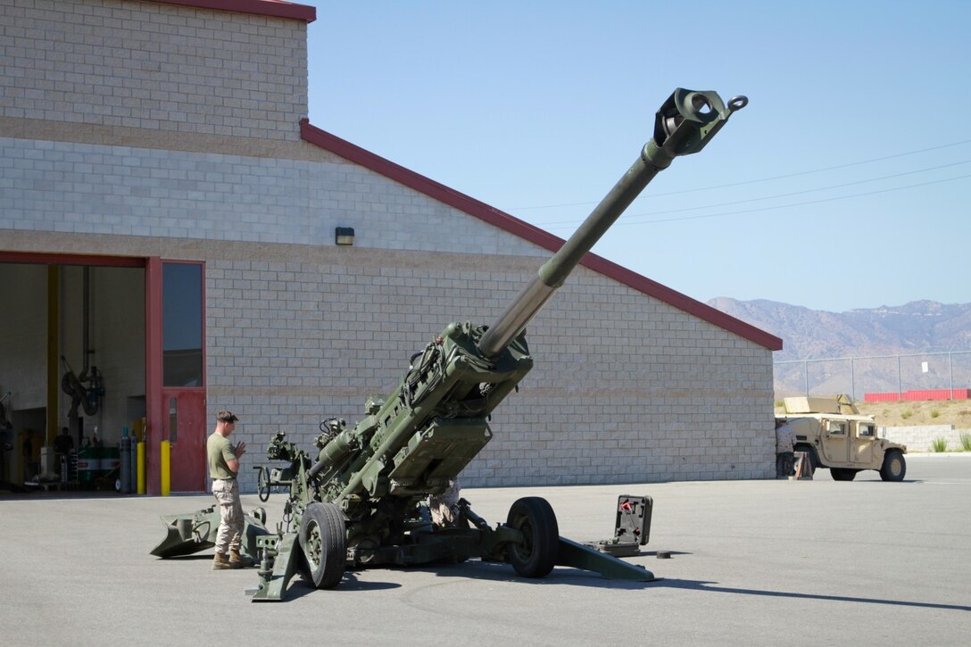 Marines serving with 2nd Battalion, 11th Marine Regiment, provide preventative maintenance to an M777 Lightweight Howitzer at the 11th Marines' gun park here, Aug. 14, 2013. The Marines prepped the howitzer for the upcoming regimental fire exercise Aug. 19 through 28.