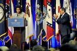 Defense Secretary Leon E. Panetta applauds First Lady Michelle Obama at the Pentagon, Feb. 15, 2012, as they announce a new report focusing on ways to streamline licensing regulations across state lines for military spouses seeking employment.