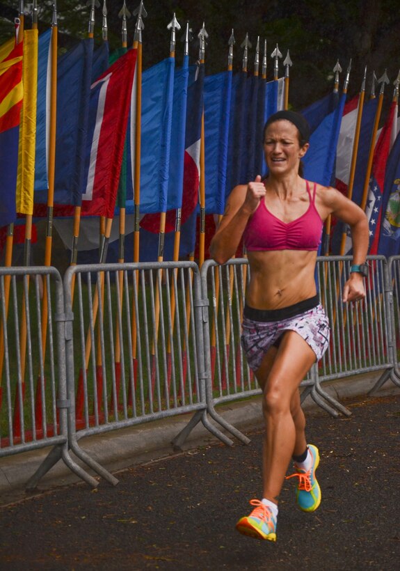 Priscilla Shaw pushes herself toward the finish line during the Tradewind Triathlon, Aug. 11, 2013. Shaw came in 1:06:33, bringing her team, Lightning, in second place in the relay category. (U.S. Marine Corps photo by Kristen Wong)