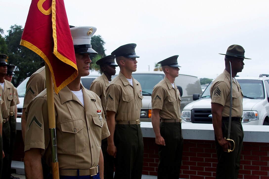 Pfc. Stephen Alessandria, honor graduate for platoon 3062, stands at attention with Sgt. Leroy McGee, Senior Drill Instructor for platoon 3062, before graduation aboard Parris Island, S.C., Aug. 16, 2013. Alessandria, a native of Jacksonville, Fla., was by Sgt. Catherine Light, recruiter from Recruiting Substation Jacksonville Beach, Recruiting Station Jacksonville. Alessandria will be able to enjoy some much deserved leave with his family after graduation. (U.S. Marine Corps photo by Lance Cpl. John-Paul Imbody)