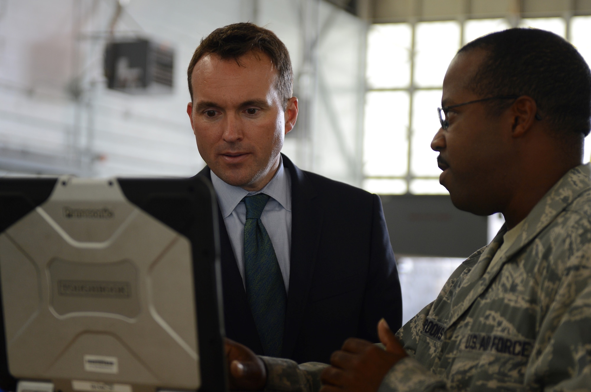 Tech. Sgt. Kenji Brooks shows Acting Secretary of the Air Force Eric Fanning electronic technical orders Aug. 14, 2013, on Barksdale Air Force Base, La., . Technical orders are step-by-step instructions that maintainers use to safely complete their maintenance tasks. Brooks is an aerospace ground equipment craftsman with the 2nd Maintenance Squadron.