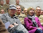 Army Gen. Martin E. Dempsey, chairman of the Joint Chiefs of Staff, and his wife, Deanie, enjoy a USO show with service members at Bagram Airfield, Afghanistan, Dec. 16, 2011. Through social media and contacts with service members and families, Deanie Dempsey discusses issues that include programs for military families overseas, jobs for military spouses, military family health, and her travels with the chairman.