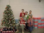 Army Spc. Shane Whitacre, 2175th Military Police Company, with his family at the unit's holiday party. The party fell just before Whitacre was scheduled for shoulder surgery.