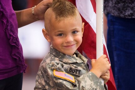 Gunner Butt, son of Sgt. 1st Class Walter Butt, stands with his family waiting for the return of their deployed Soldier at the Indiana National Guard, 3-19th Agribusiness Development Team from Afghanistan at Stout Field, Indianapolis, Ind., Aug. 10.