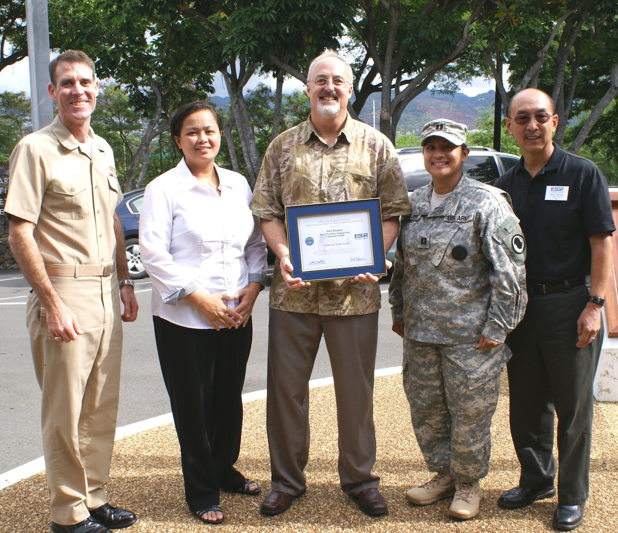 Naval Facilities Engineering Command (NAVFAC) Pacific Public Affairs Officer Don Rochon (center) was presented with an Employer Support of the Guard and Reserve (ESGR) Patriot Award Nov. 30, 2011. (L-R) Capt. Pete Lynch, NAVFAC Pacific vice commander, Christine Rosalin, NAVFAC Pacific public affairs specialist, Rochon, Capt. Melina Juan, 117th Mobile Public Affairs Detachment commander, and Sam Wong, ESGR representative all posed for a photo at NAVFAC Pacific headquarters. Rosalin nominated Rochon for this special award for his leadership, mentorship and support for her National Guard deployment requirements.
