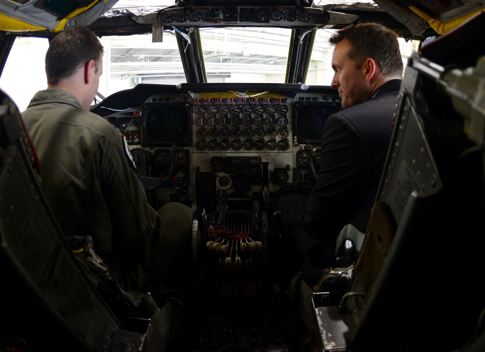 Capt. Shane Praiswater speaks with Acting Secretary of the Air Force Eric Fanning about the flight deck of the B-52H Stratofortress during Fanning's visit to Barksdale Air Force Base, La., Aug. 14, 2013. Fanning was introduced to the 2nd Bomb Wing's mission and the capabilities of the B-52 during a tour of the bomber. Praiswater is a 20th Bomb Squadron Charlie Flight assistant commander.
