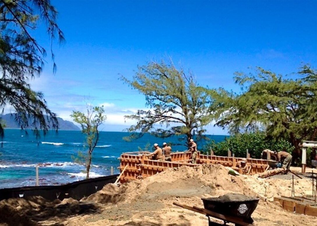 MARINE CORPS BASE HAWAII — Construction Battalion Maintenance Unit 303 Detachment Pearl Harbor Seabees work on the frame for a new cottage along the shores of Kaneohe Bay. The unit recently completed the cottage for Marine Corps Base Hawaii. (Photo by Petty Officer 1st Class Rouel Agustin)