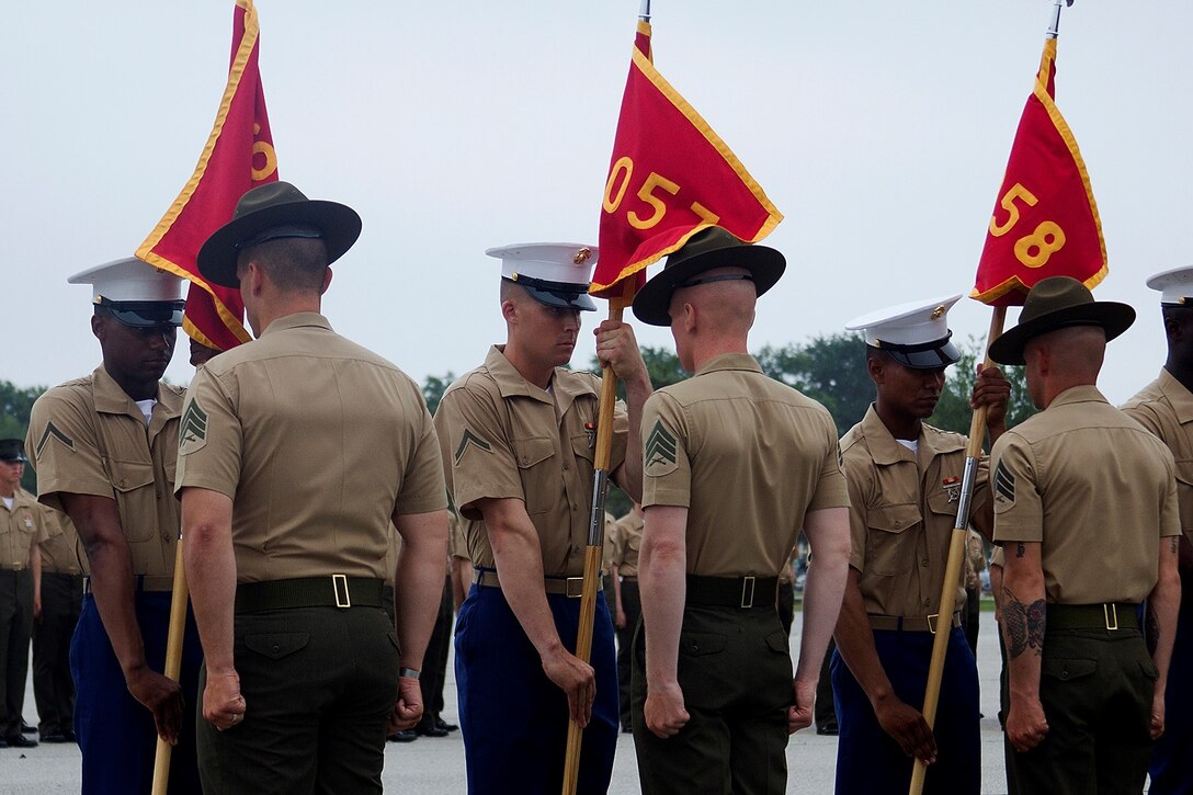 From left to right; Pfc. Dominique Starr, honor graduate of platoon 3056 and company honor graduate, Pfc. Allan Lammon, honor graduate of platoon 3057, and Pfc. Jildardo Reofrio, honor graduate of platoon 3058, all are preparing to retire the guidon to their drill instructors during graduation aboard Parris Island, S.C., Aug. 16, 2013. Starr, native of and recruited from Knoxville, Tenn., by Sgt. Lance Barber, Lammon, native of Theodore, Ala. and recruited from Mobile, Ala., by Sgt. Ricky Bergman, and Reofrio, native of Dade City, Fla., and recruited from Wesley Chapel, Fla., by Staff Sgt. Julio Carrasco, will all be able to enjoy some much deserved leave after graduation. (U.S. Marine Corps photo by Lance Cpl. John-Paul Imbody)