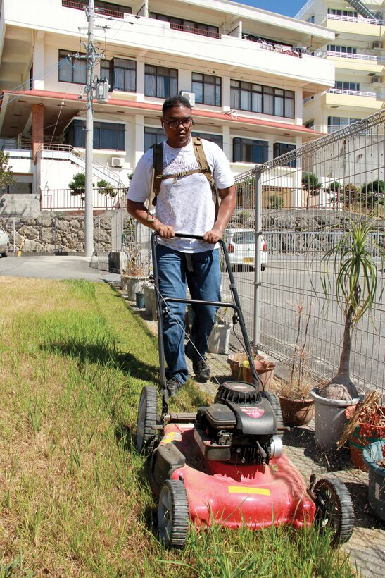 Seaman Apprentice Charles J. Foster mows grass Aug. 2 at the Ichijo-en Elders’ Home. Marines and sailors with Marine Aircraft Group 36, 1st Marine Aircraft Wing, III Marine Expeditionary Force, volunteered to give back to the community by helping with groundskeeping. “We are currently working on developing a partnership between the elders’ home and MAG-36, to come out at least once a month to help with anything they might need,” said Foster, a religious program specialist with MAG-36, 1st MAW, III MEF. Photo by Lance Cpl. Donald T. Peterson