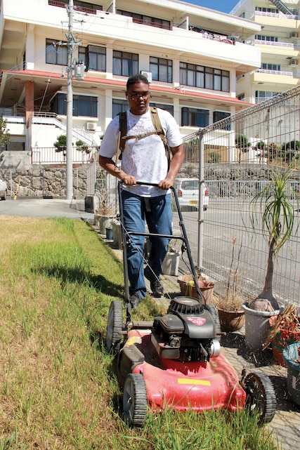 Seaman Apprentice Charles J. Foster mows grass Aug. 2 at the Ichijo-en Elders’ Home. Marines and sailors with Marine Aircraft Group 36, 1st Marine Aircraft Wing, III Marine Expeditionary Force, volunteered to give back to the community by helping with groundskeeping. “We are currently working on developing a partnership between the elders’ home and MAG-36, to come out at least once a month to help with anything they might need,” said Foster, a religious program specialist with MAG-36, 1st MAW, III MEF. Photo by Lance Cpl. Donald T. Peterson