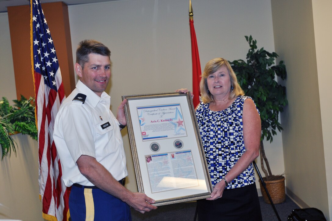 Lt. Col. John Hudson, U.S. Army Corps of Engineers Nashville District commander presents Avis Kennedy, a retired Nashville District employee the Distinguished Civilian Employees award at the Estes Kefauver Federal Building on Aug. 15, 2013.   The award is presented to retired employees that have been retired for two or more years with at least 20 years of service and have displayed outstanding leadership with exception and preeminence among their peers and contributed substantially to the reputation and honor of the Corps of Engineers through their service. 
