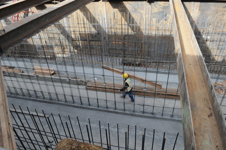A construction worker carries lumber through a set of box culverts under construction along Napa Creek in Napa, Calif., Jan. 18, 2012. The culverts – tunnels large enough for a car to drive through – will channel flood water from the creek more quickly to the Napa River and way from homes and businesses. The $14.8 million project, funded by the American Recovery and Reinvestment Act of 2009, was a joint effort of the U.S. Army Corps of Engineers Sacramento District, the city of Napa and the Napa Flood Control and Water Conservation District to reduce flood risk for the city.
