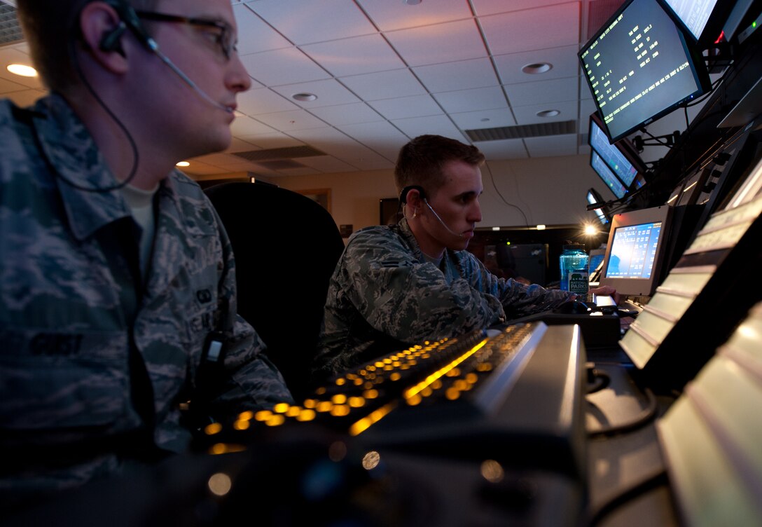 Airman 1st Class Bo Guist (left) and Brody Schneider, 28th Operations Support Squadron air traffic controllers, monitor the terminal radar sensor for aircraft at Ellsworth Air Force Base, S.D., Aug. 13, 2013. The Ellsworth AFB air traffic control radar approach facility controls 15 civilian satellite airports, two Air Force bases, and more than 22,000 sq. miles of airspace spanning over five states. (U.S. Air Force photo by Airman 1st Class Alystria Maurer/Released)