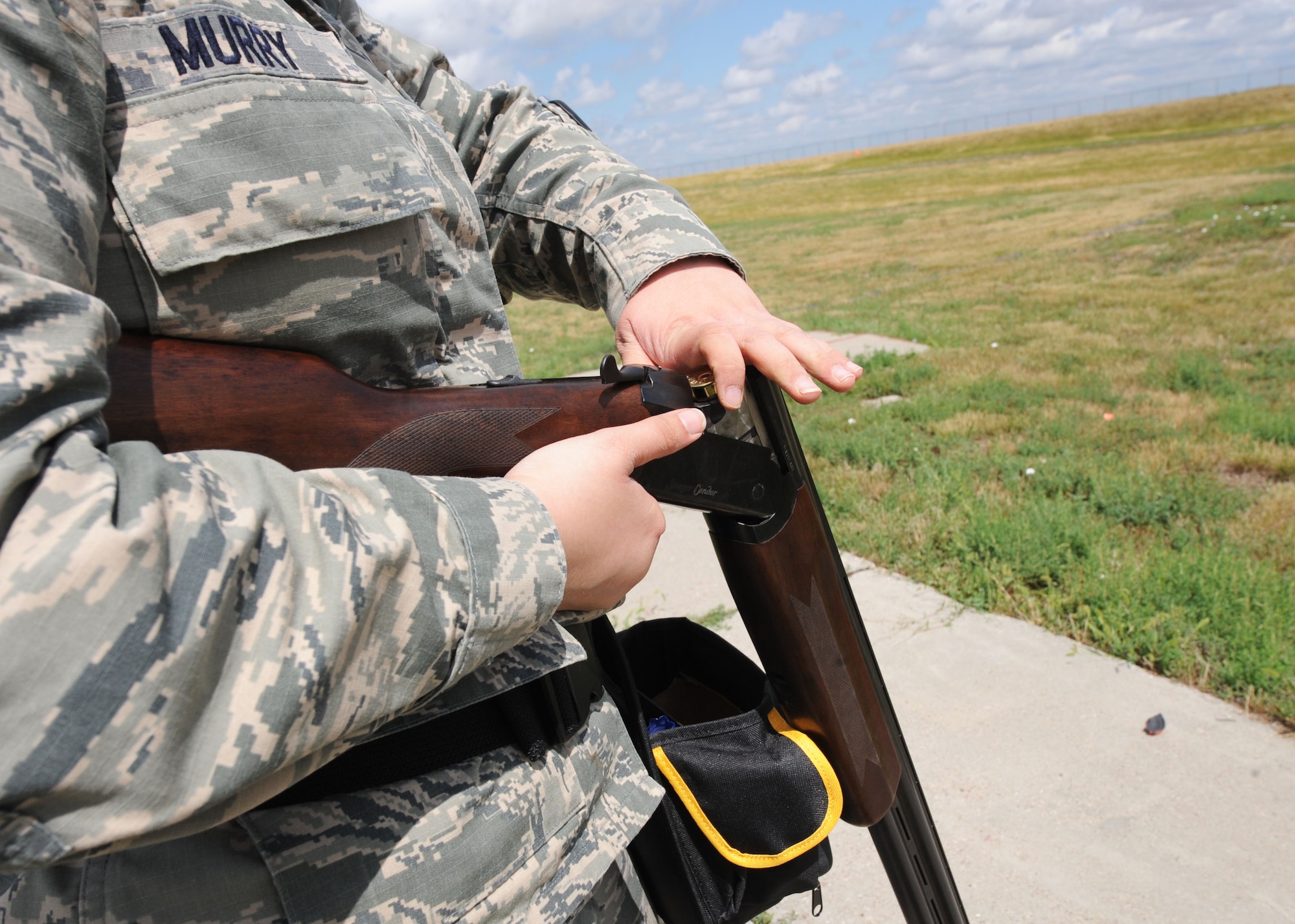 Airman 1st Class Amber Murry, 28th Communication Squadron cyber transport system technician, reloads a shotgun during the Command Chief Challenge at the Trap and Skeet Range on Ellsworth Air Force Base, S.D. Aug. 9, 2013. The Trap and Skeet Range is available to Airmen and their families through outdoor recreation. For more information, call (605) 385- 2999. (U.S. Air Force photo by Airman 1st Class Rebecca Imwalle/Released)