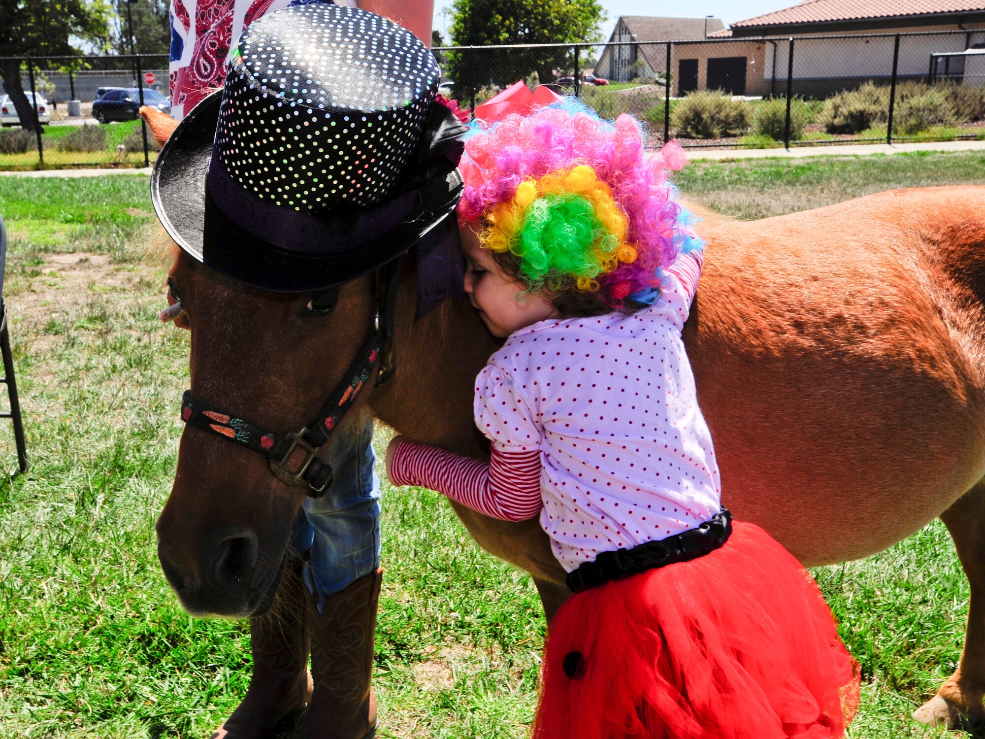 VANDENBERG AIR FORCE BASE, Calif. – Scout French hugs Teacup, a miniature horse from Santa Ynez Valley therapeutic riding program, during the 4th annual Salute to Youth event here Thursday, August 15, 2013. Salute to Youth was both an educational and family friendly event. It hosted the Exceptional Family Member Program, local schools, Backpack Brigade, food, games and prizes. (U.S. Air Force photo/Airman Yvonne Morales)
