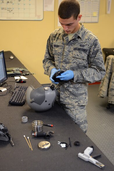 Airman 1st Class Michael Fields, 2nd Operations Support Squadron flight equipment journeyman, disassembles a light-weight helmet on Barksdale Air Force Base, La., Aug. 16, 2013. The helmet was taken apart so each piece could be inspected and cleaned for optimal servicability. (U.S. Air Force photo/Senior Airman Micaiah Anthony)