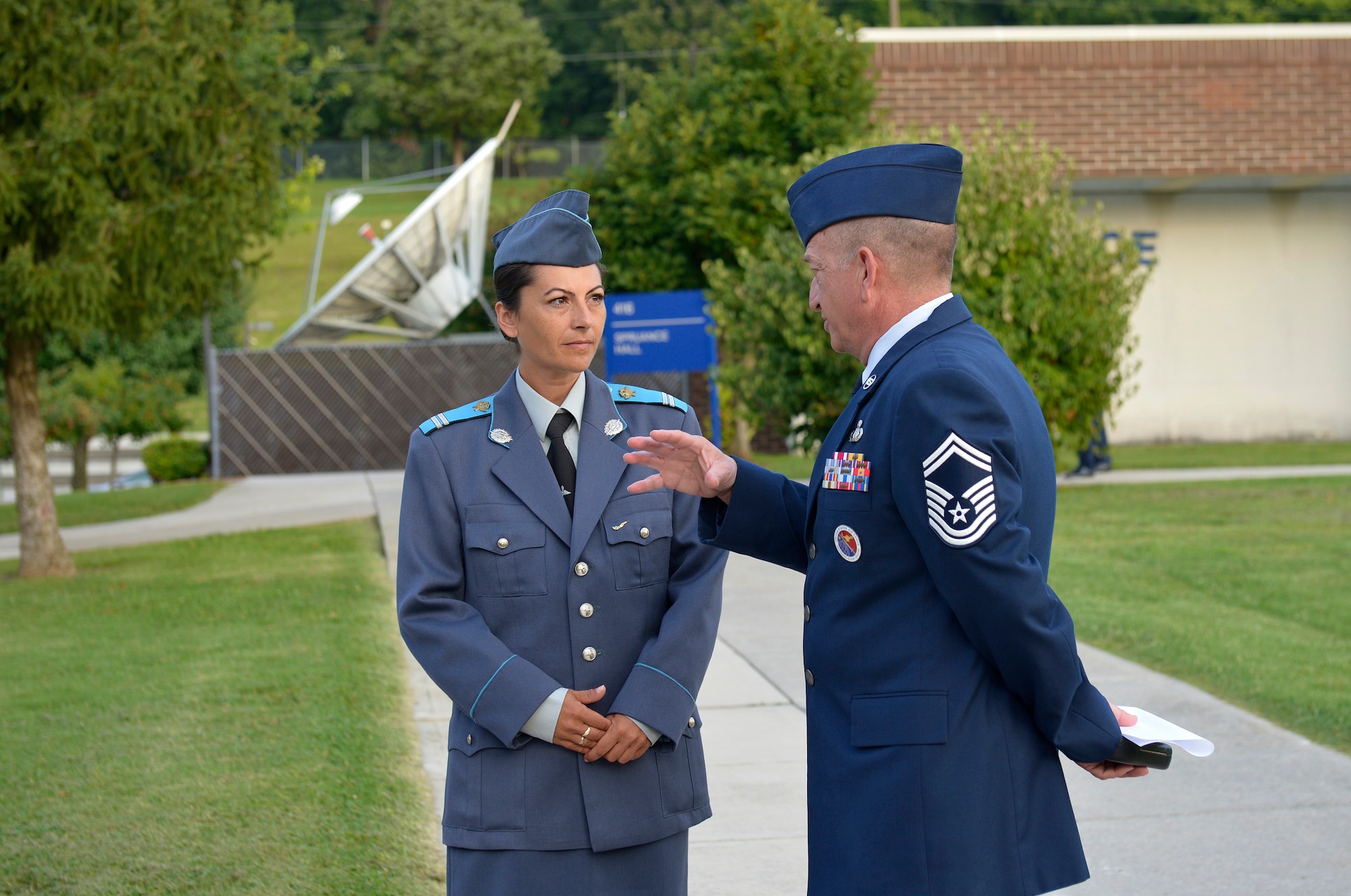 MCGHEE TYSON AIR NATIONAL GUARD BASE, Tenn. - Sergeant Yordanka S. Petrova-Angelova with the Bulgarian air force talks with U.S. Air Force Senior Master Sgt. Andrew Traugot, director of education, Satellite EPME, here August 15, 2013, on the campus of the I.G. Brown Training and Education Center. Petrova-Angelova graduated from the U.S. Air Force Noncommissioned Officer Academy instructed by the Paul H. Lankford Enlisted PME Center.   She and Bulgarian Corporal Stoyko V. Stoykov, who attended Airman Leadership School at around the same time, completed the leadership education this summer as part of relations built through the Tennessee National Guard State Partnership Program. (U.S. Air National Guard photo by Master Sgt. Kurt Skoglund/Released)